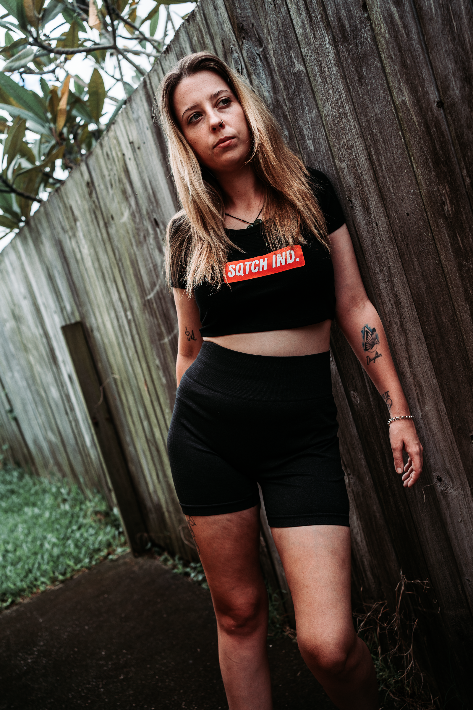 Sqtch Industries women’s underground streetwear crop tee styled in outdoor urban setting